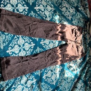 A darker brown pair of jeans with a lighter brown stitching